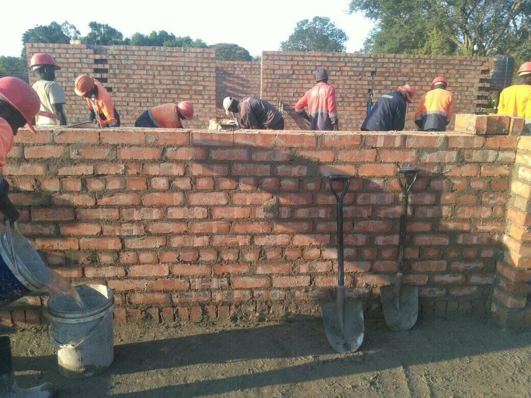Robur Construction team building a brick wall